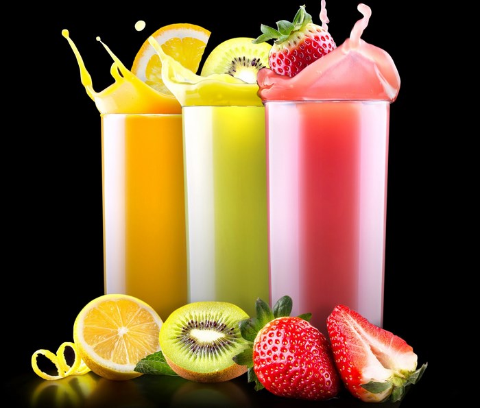 Three glasses of fruit juice with fruits