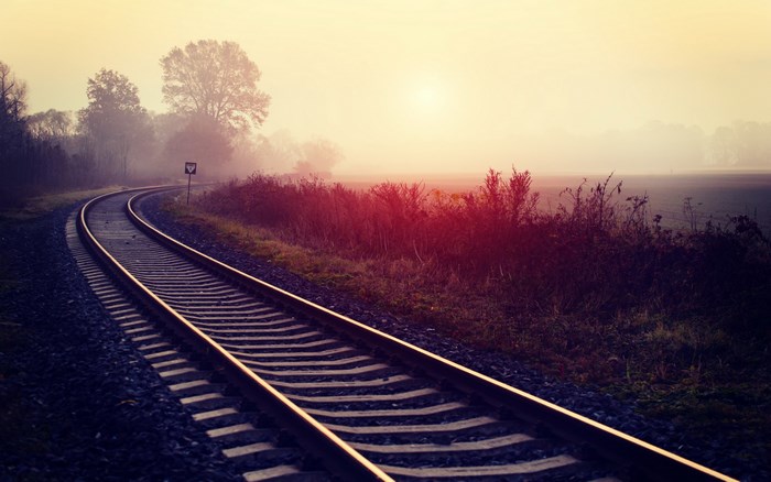 Railroad tracks in a foggy landscape