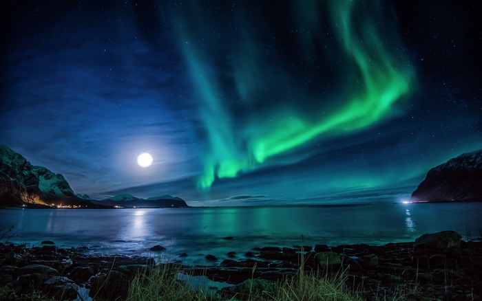 Aurora Borealis over a moonlit bay