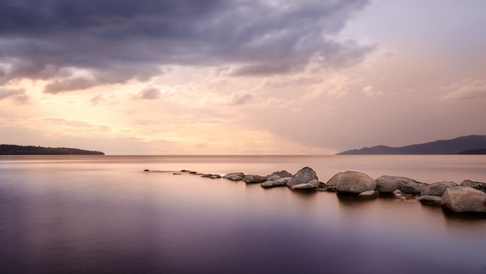 Rocks in calm water at sunset