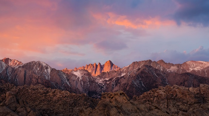 Mountain range at sunrise with pink clouds