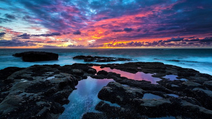 Sunset over rocky coast 4K