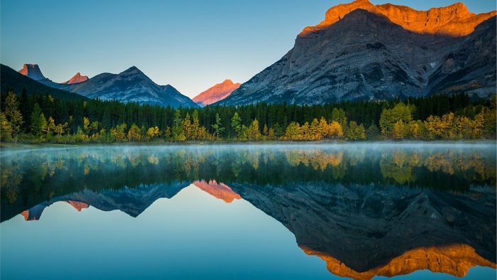 Mountain range reflected in a lake at sunrise
