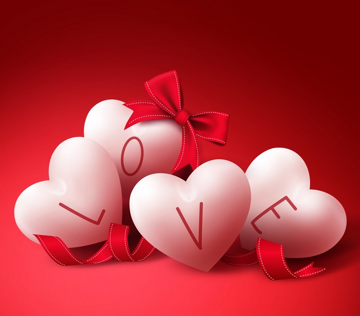 Four white hearts with the word LOVE and a red ribbon