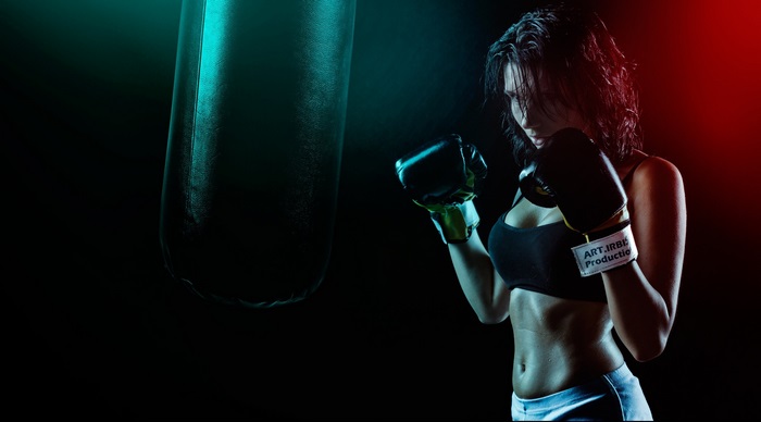 Woman boxing with a punching bag in 4K