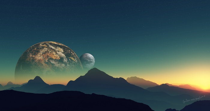 Distant planets over mountain range at sunset