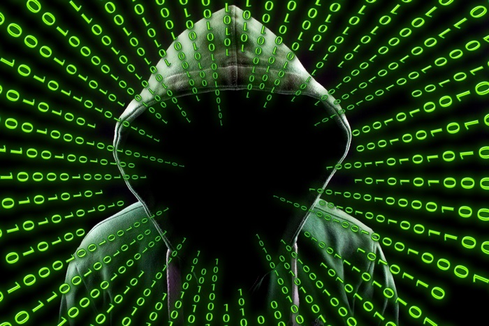 Hooded figure with binary code