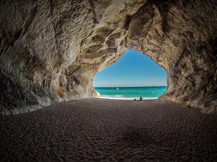 Cave opening to a beach and ocean