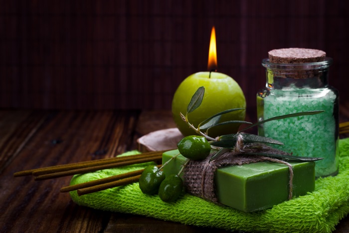 Spa items with candle and olives