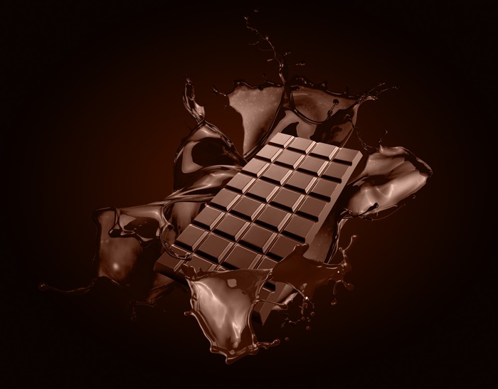 Chocolate bar splashing in liquid chocolate