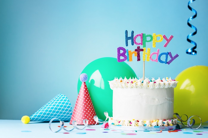 Birthday cake with decorations and balloons