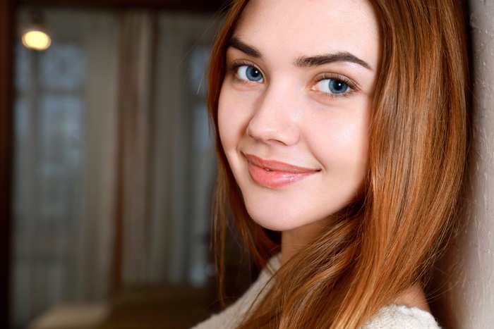 Woman with auburn hair and blue eyes