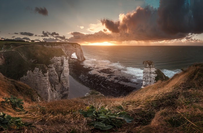 Etretat cliffs and arch at sunset