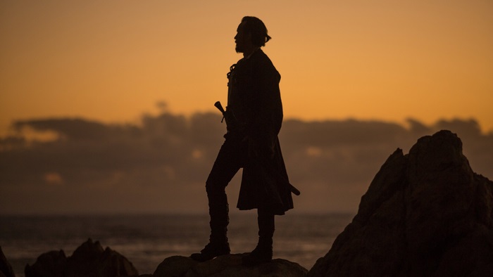 Man with sword from Black Sails at sunset