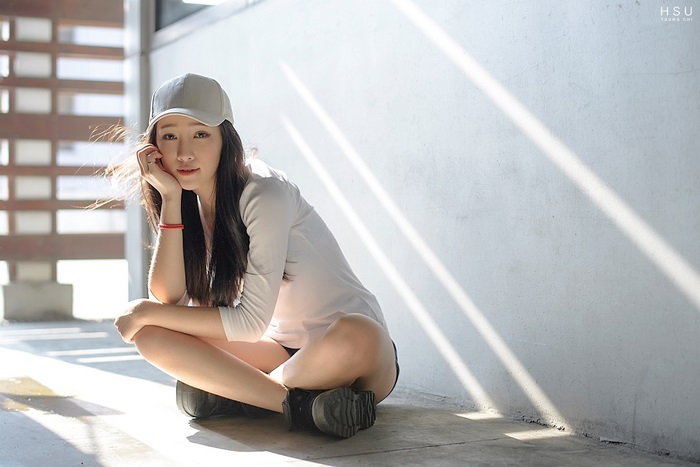 Young Asian woman wearing a cap and white shirt