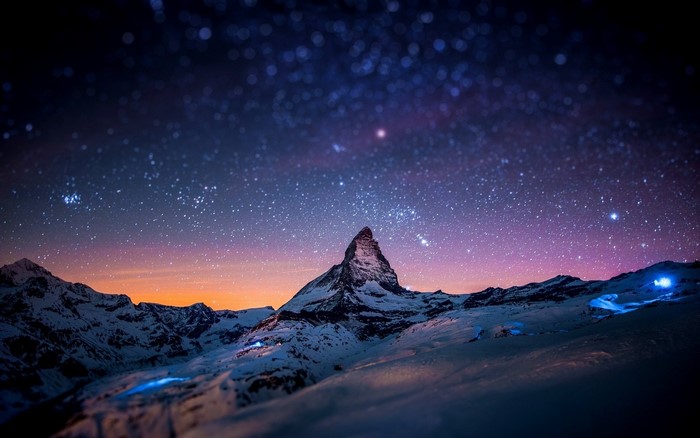 Matterhorn mountain under a starry night sky