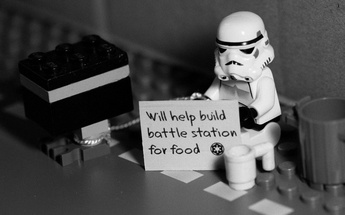 Stormtrooper from Star Wars holding a sign for food