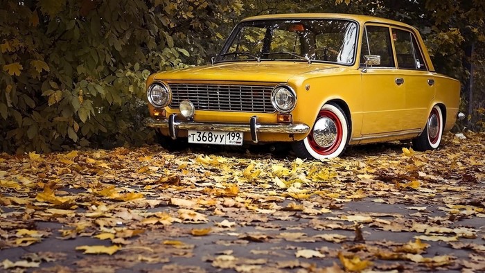 Yellow Lada 2101 car in autumn leaves