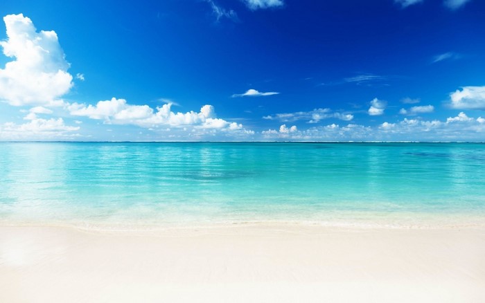 Tropical beach with turquoise water and blue sky