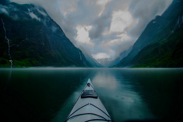 Kayaking through a misty fjord in Norway