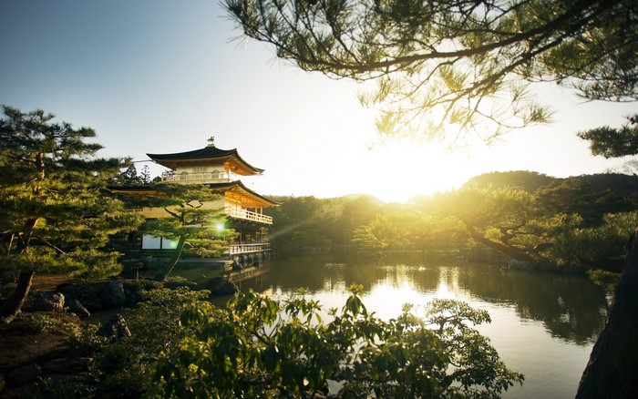 Golden Pavilion temple reflecting in a pond at sunrise