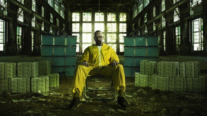 Walter White from Breaking Bad in a warehouse with money