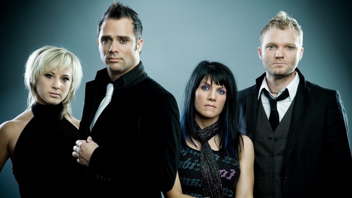 Skillet band members posing for a photo