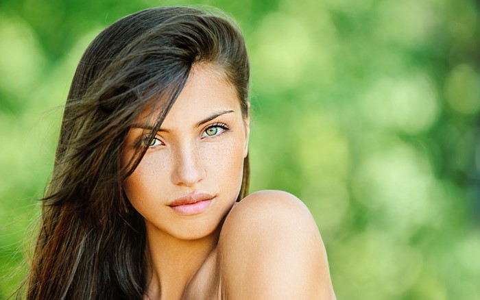 Woman with long brown hair and green eyes