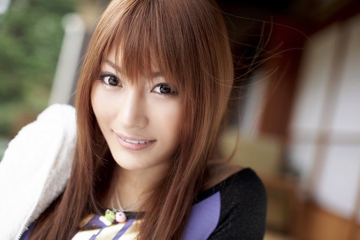 Asian woman with brown hair and bangs