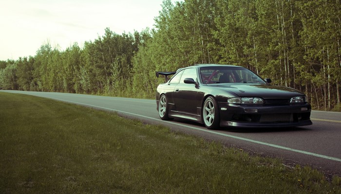 Nissan Silvia S14 on a road with trees
