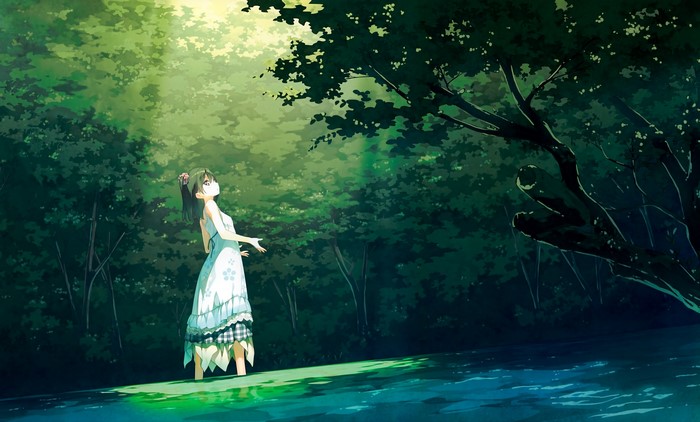 Girl in a white dress in a sunlit forest
