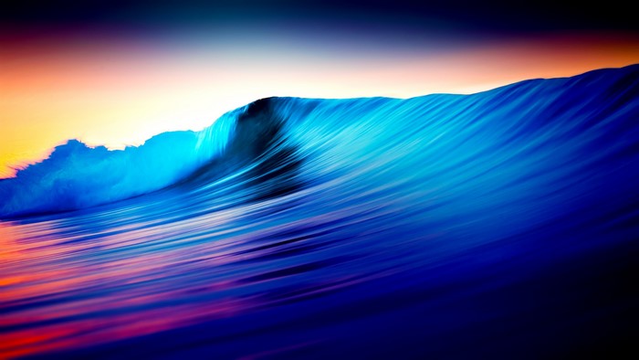 Colorful ocean wave at sunset