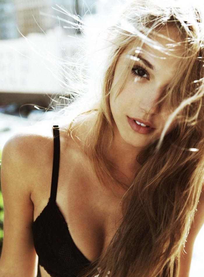 Alexis Ren, a blonde woman wearing a black bra