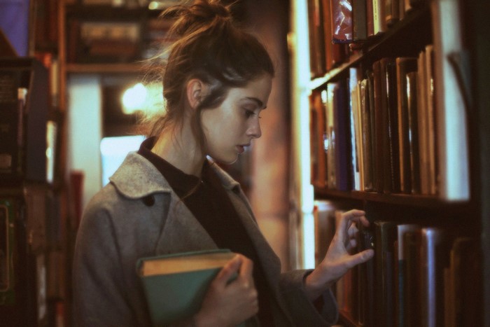Woman browsing books in a library