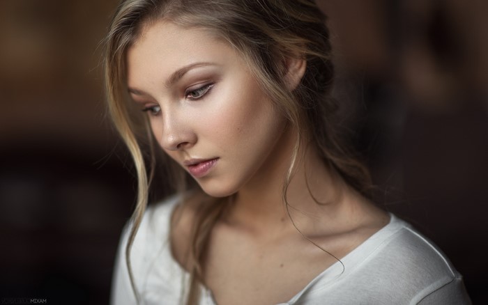 Woman with blonde hair in a white shirt