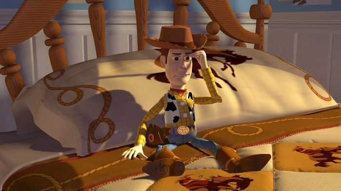 Woody from Toy Story on a bed