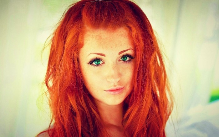 Woman with red hair and green eyes