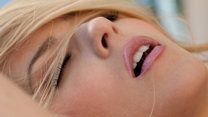 Closeup of a Blonde Woman with Eyes Closed