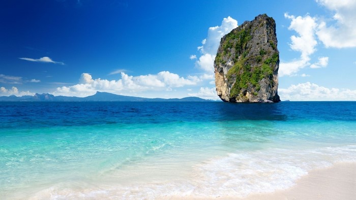 Serene Thailand Beach with Towering Rock Formation