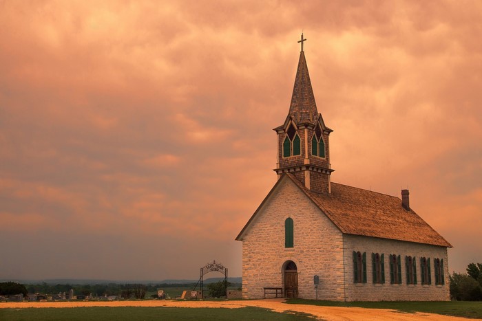 Quiet Church with Cemetery under Sunset Sky