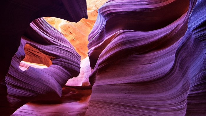 Antelope Canyon rock formations with purple and orange light