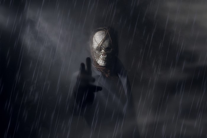 Person with mask in the rain
