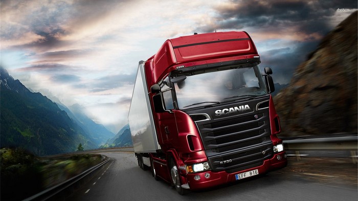 Red Scania Semi-Truck Driving Through Mountain Road