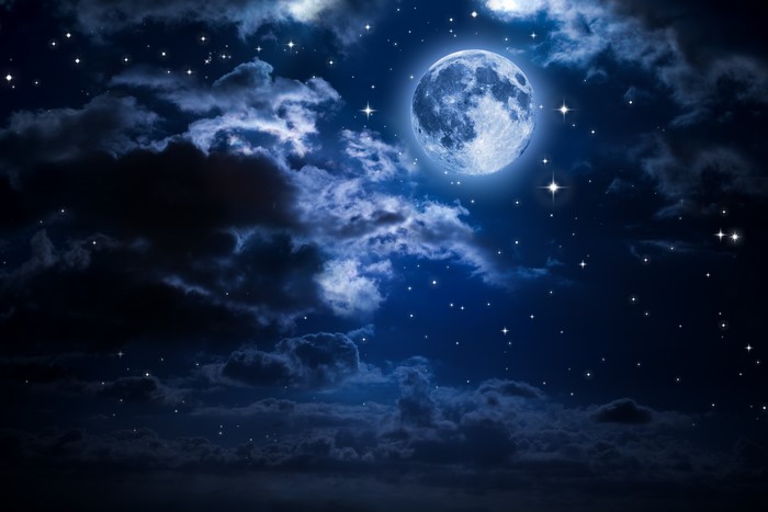 Bright Full Moon Shining Through Night Clouds