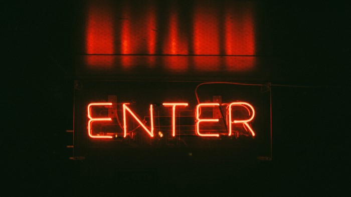 Red neon sign that says ENTER