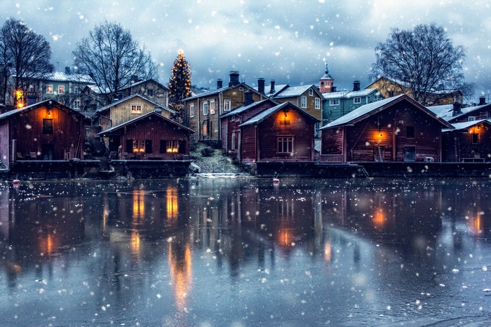 Winter village with Christmas tree by the water
