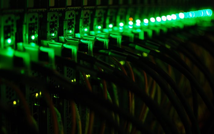 Server rack with blinking green lights and cables