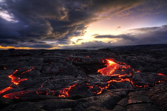 Molten Lava Flowing Across Rocky Landscape at Sunset in Indonesia