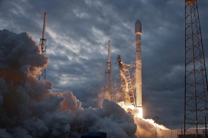 SpaceX Falcon 9 rocket launch with smoke