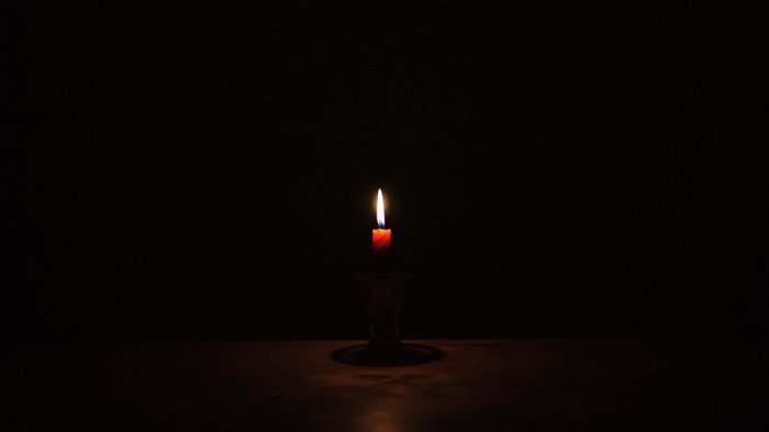 Candle burning in the dark